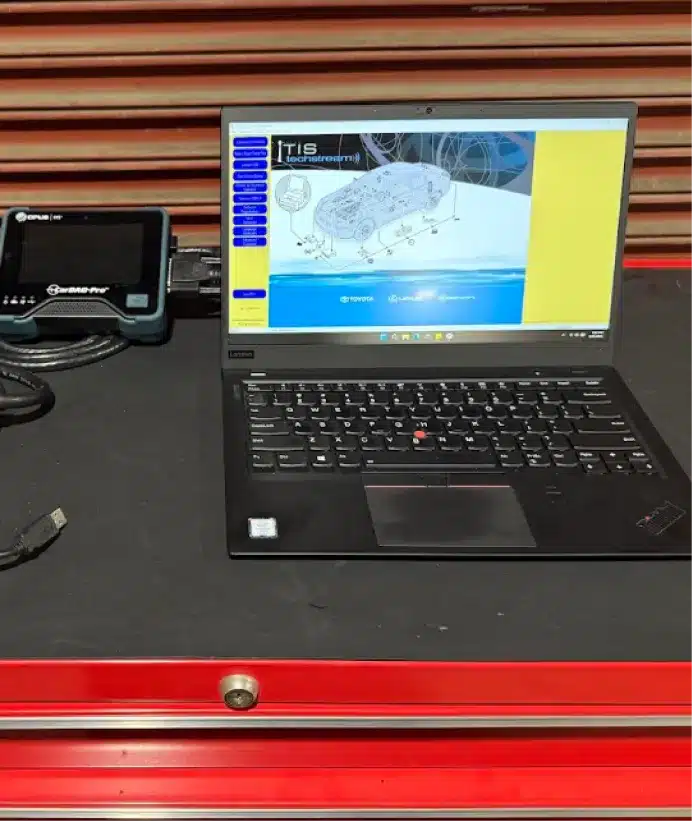 Auto diagnostics & electrical repair, auto repair in Walnut Creek, CA at N Service Auto Repair and Service. A laptop displaying a technical diagram is on a black and red workbench, next to an automotive diagnostic tool and some cables.